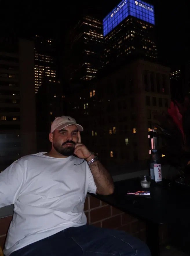 Roni on a rooftop in New York at night